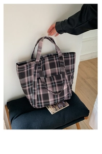 Detail shot of large capacity plaid tote bag with sturdy woven fabric and long handles