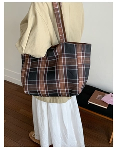 Side view of a large plaid tote bag worn over the shoulder for a casual everyday look
