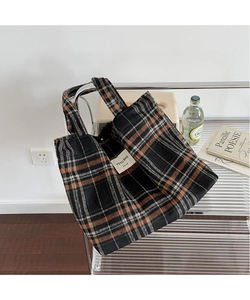 Close-up of vintage plaid tote bag with textured wool fabric and interior brand label