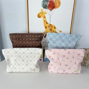 Trapezoid corduroy makeup bags in four plaid patterns with zip closure and fabric label