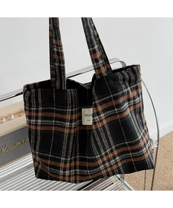 Detail of plaid tote bag with handmade label texture and British vintage check pattern