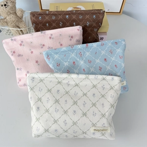 Corduroy bow cosmetic bag in four colors including floral and plaid patterns for travel