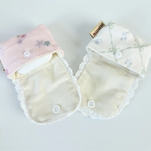 Detail view of corduroy and plaid earphone cases with lace trim and resin snap closure
