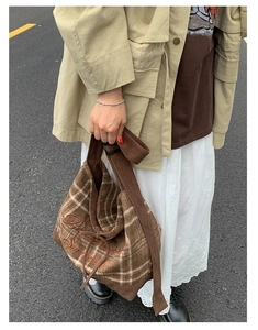 Detail of vintage brown plaid corduroy tote bag with embroidered text and large capacity