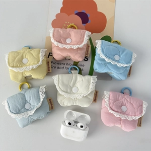 Detail of quilted fabric AirPods cases with white lace trim and colorful hooks