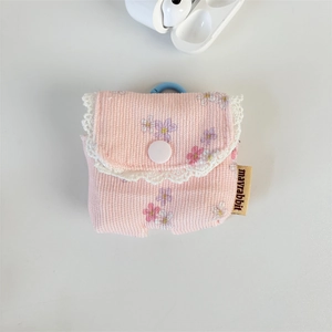 Detail of pink floral corduroy headphone case featuring lace trim and a secure blue carabiner