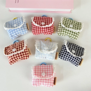 Flat lay of colorful gingham earphone cases with lace trim and hanging hooks
