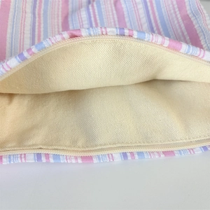 Detailed view of the smooth zipper and beige fabric lining of the striped makeup bag