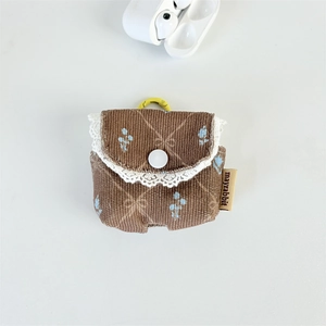 Close-up of brown corduroy earphone pouch with blue floral pattern and white lace edge