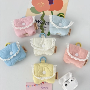 Detailed macro view of quilted candy color earphone cases with white lace floral trim