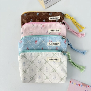 Detail of assorted floral corduroy pouches in brown, pink, blue and white colors