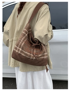 Detail view of vintage brown plaid shoulder bag with embroidery and velvet texture