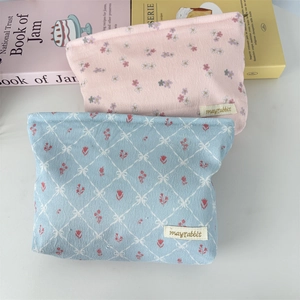 Corduroy bow cosmetic bag in pink floral and blue check patterns with soft texture