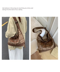 Macro detail of brown plaid corduroy shoulder bag featuring embroidery and drawstring bow