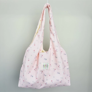 Detailed macro view of the floral canvas texture and pink mayrabbit fabric label
