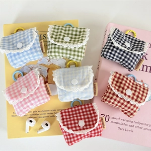 Detailed view of floral plaid fabric earphone cases with lace trim and hanging hooks