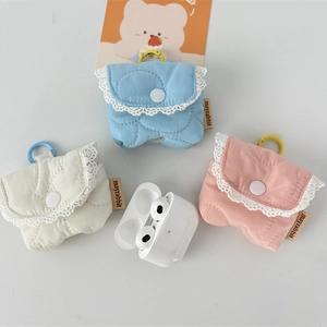 Macro view of quilted flip earphone pouches with lace edges in blue white and pink
