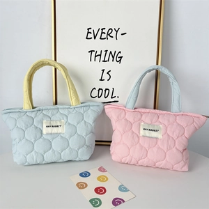 Close-up of quilted bubble texture candy-colored tote bags with MAY RABBIT labels