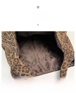 Detail shot of the brown interior lining and open inner pocket of the leopard tote bag