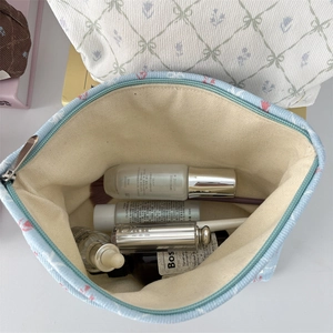 Top view of open floral corduroy makeup bag showing large capacity for toiletries