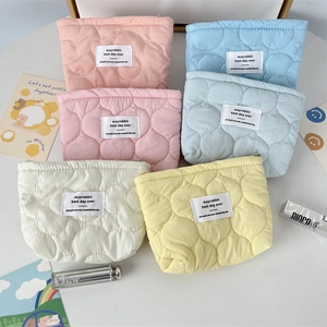 Quilted pastel floral makeup bags in six macaron colors with cloud textures and zip closure