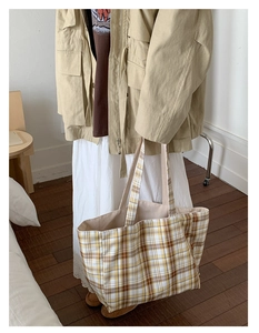 Detail of checkered canvas tote bag with retro yellow and brown pattern for women