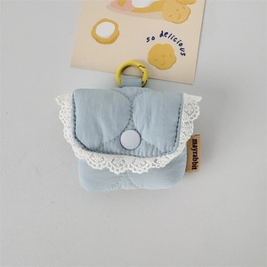 Quilted light blue fabric earphone case with white lace trim and a yellow hanging loop