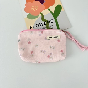 Detail of pink corduroy floral coin purse with a soft texture and sturdy zipper closure