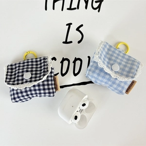 Detailed view of plaid fabric earphone cases with lace trim and yellow hanging rings