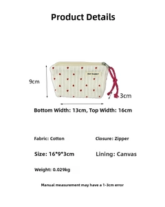 Detail of cream striped cotton makeup bag with red heart embroidery and size dimensions