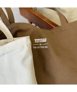 Detail showing high-quality canvas fabric texture and YEYUBAG brand logo on tote bag