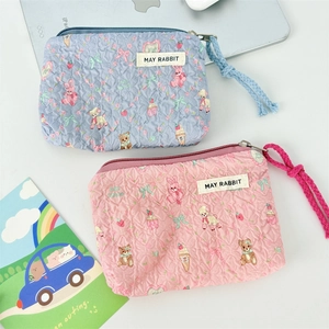 Close-up of quilted floral coin purses in pink and blue with cute animal prints