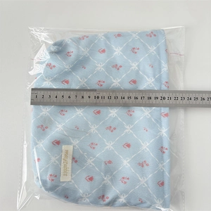 Detail view showing a 21cm width measurement of the blue corduroy floral cosmetic bag