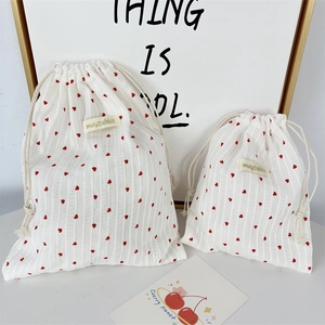 Set of two striped drawstring storage bags with red heart pattern for small accessories