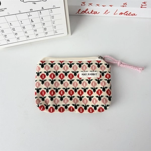 Close-up of floral storage bag with zipper and pink cord on a white background
