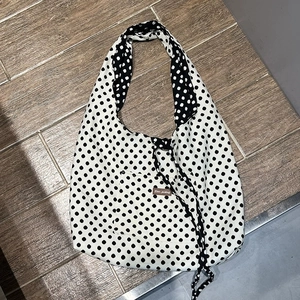 Minimalist black and white polka dot canvas tote bag with front pocket and shoulder strap