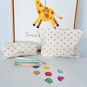 Close-up of striped heart fabric pouch set with MAY RABBIT label and embroidery