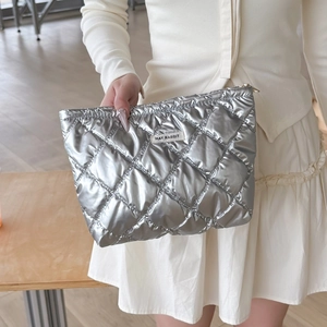 Detail of silver quilted PU makeup bag with May Rabbit label and diamond pattern