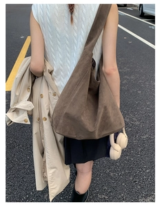Deep brown oversized suede hobo bag styled with a minimalist autumn trench coat