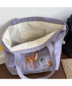 Detailed interior of the purple tote bag with mushroom embroidery and inner zipper pocket