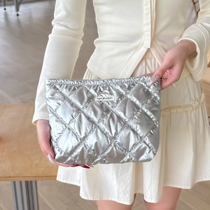 Close-up of silver quilted PU makeup bag with May Rabbit label and metallic finish