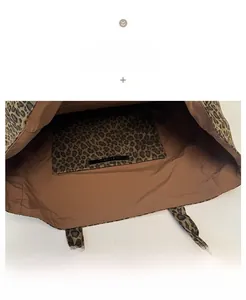 Close-up of leopard print tote bag interior showing brown lining and inner pocket