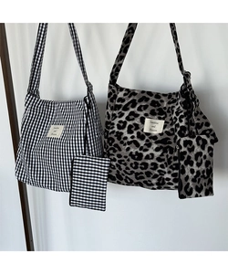 Detail of canvas tote bags with checkerboard and leopard patterns plus matching coin purses