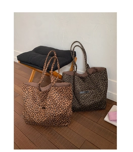 Detailed view of dual-color leopard print tote bags in classic brown and olive green