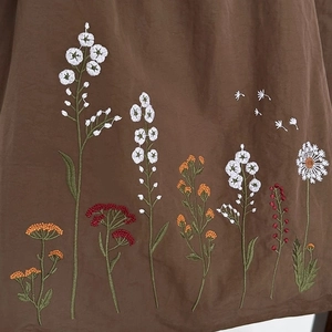 Brown nylon tote bag with colorful wildflower embroidery and spacious drawstring design