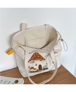 Detail view of inner zipper pocket and gray drawstring buckle on mushroom tote bag