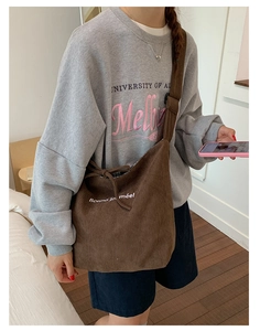 Detailed texture of brown corduroy shoulder bag with Bonne journée embroidery and drawstring