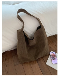 Detail shot of the large olive suede tote bag showing soft matte texture and wide strap