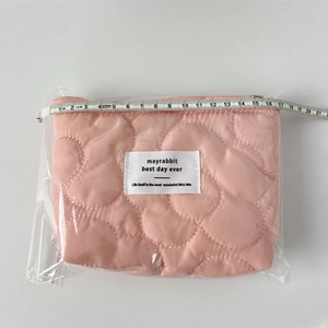 Pink quilted makeup bag with flower pattern, measuring approximately 16cm in width