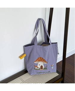 Detail of lavender canvas tote showing mushroom house embroidery and drawstring closure